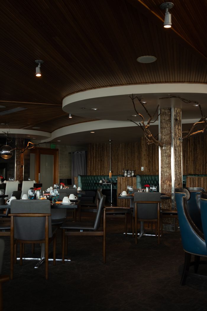 Elegant restaurant interior featuring wooden decor and ambient lighting.